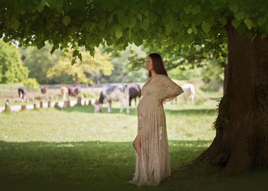 pregnant lady in cream maternity gown in field Sutton Coldfield maternity photoshoot